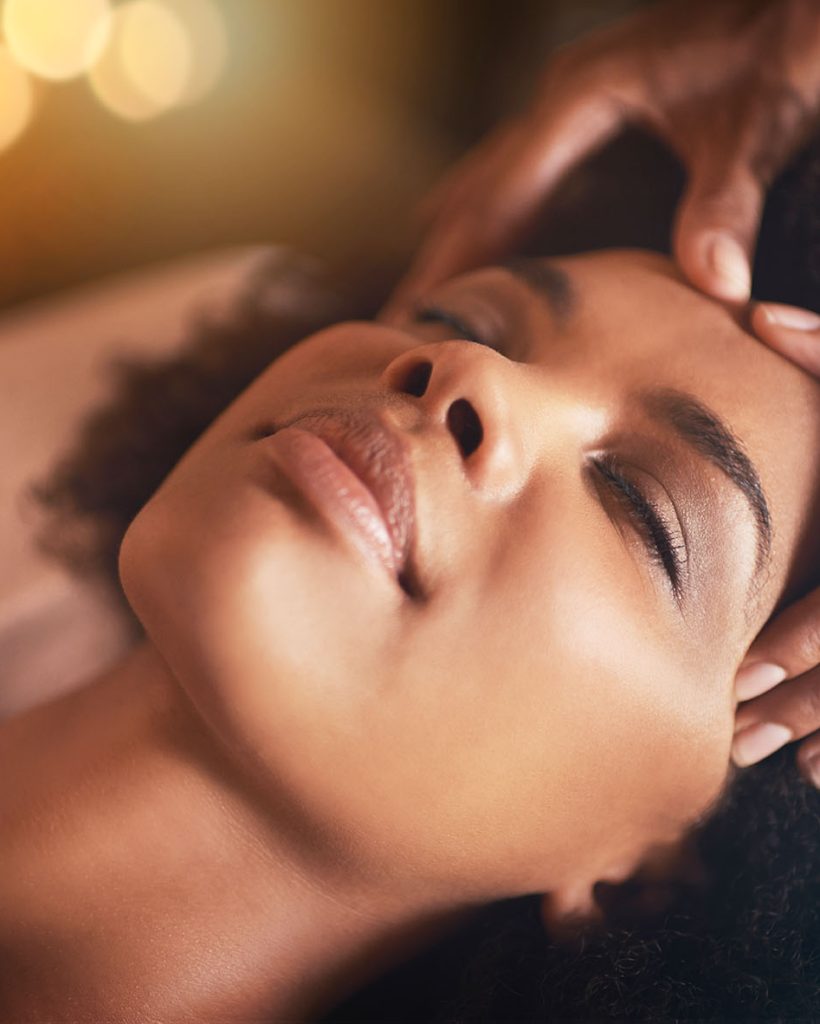 Black woman, hands and head massage with masseuse, beauty and bodycare at spa for stress relief and wellness. Closeup of face, treatment and healing for zen, self care and relax at luxury resort