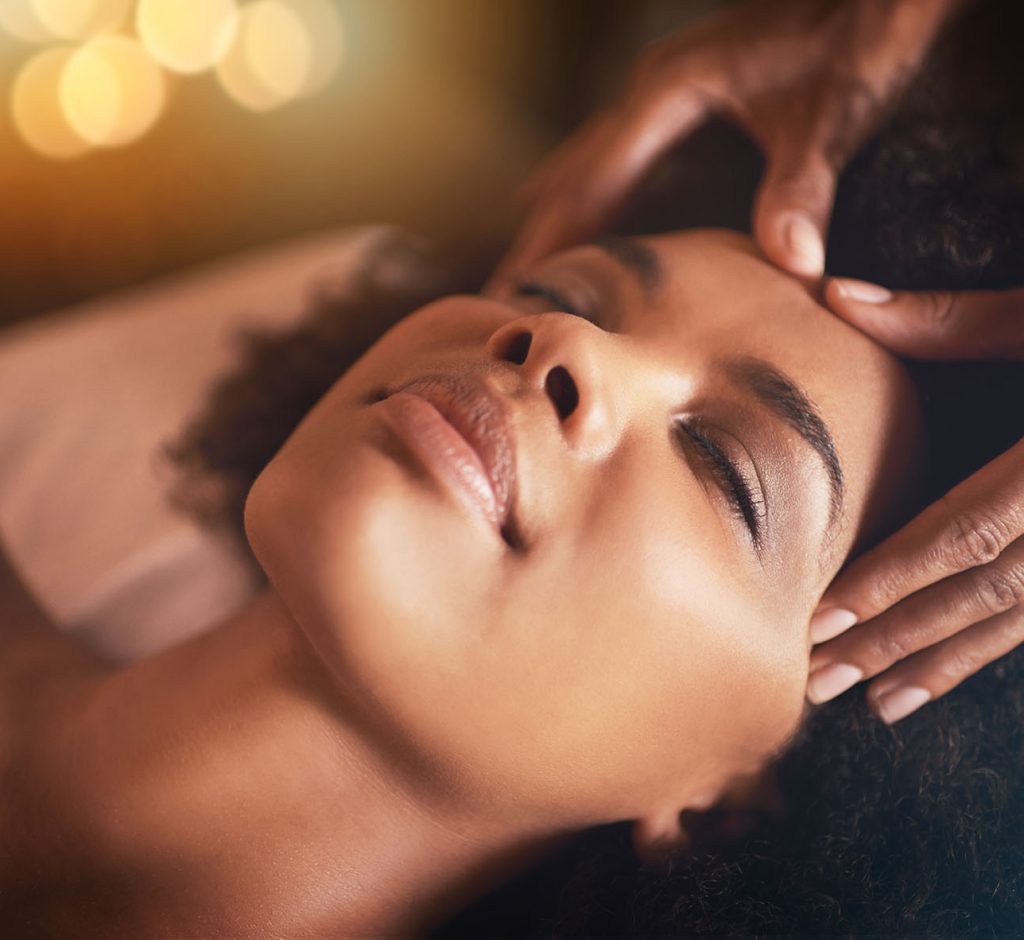 Black woman, hands and head massage with masseuse, beauty and bodycare at spa for stress relief and wellness. Closeup of face, treatment and healing for zen, self care and relax at luxury resort